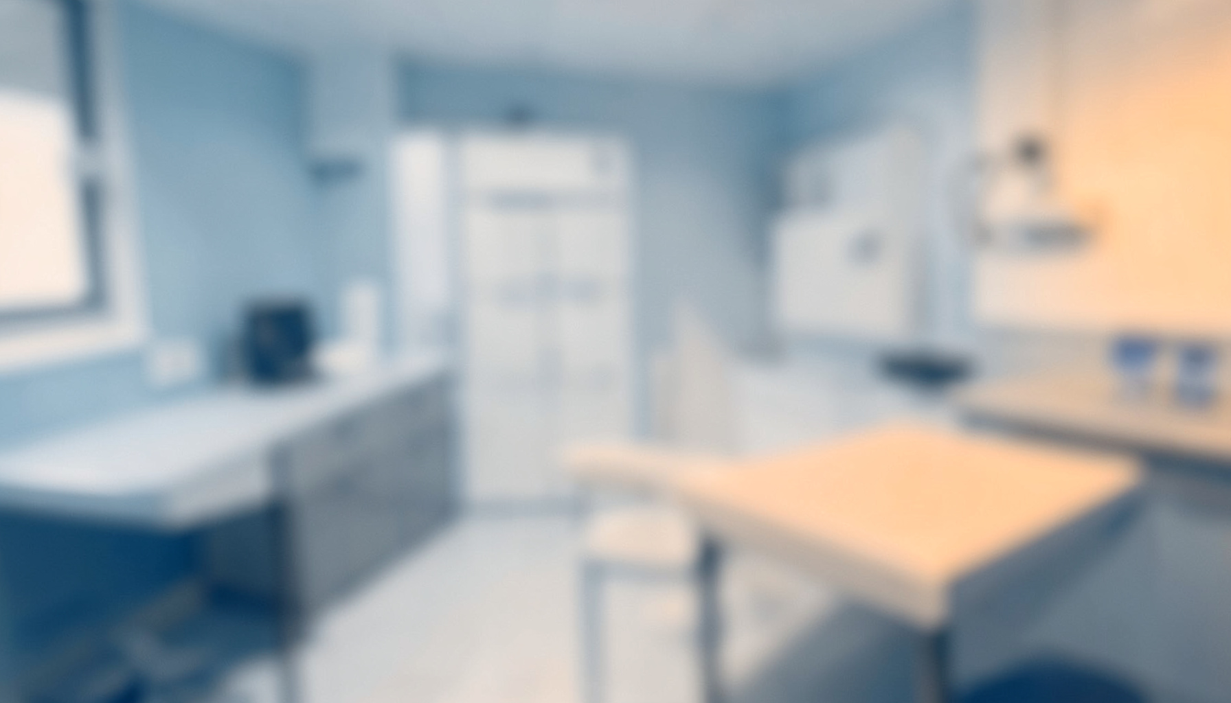 Soft-focus duotone of a clean clinical setting with muted blue and white tones and clean surfaces